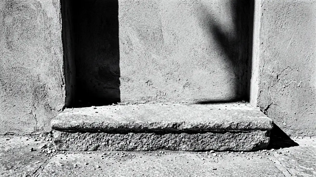 A stone threshold meeting a plastered wall under a single hard shadow